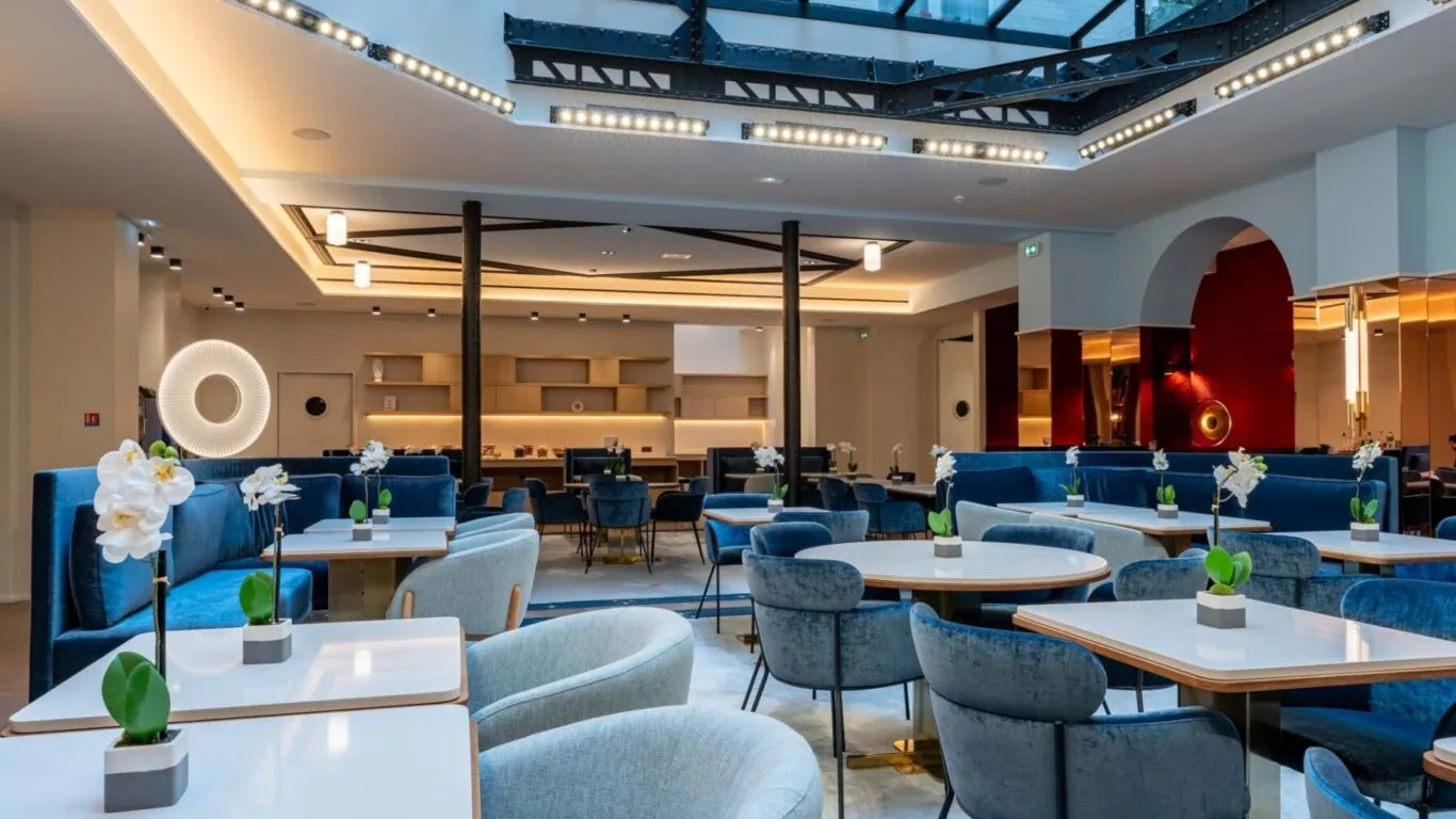 Hôtel Astra Opéra – Salle de petit-déjeuner avec des tables, des chaises et des banquettes