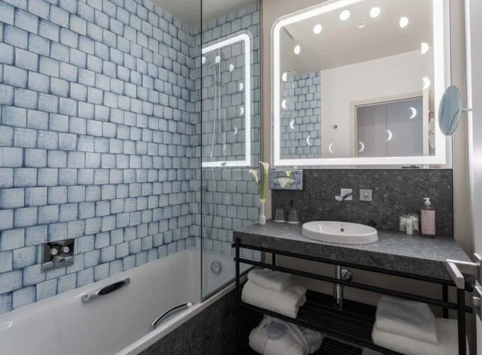 Vue de la salle de bains d’une chambre Double Supérieure Claudie Haigneré à l’hôtel Opera Astra