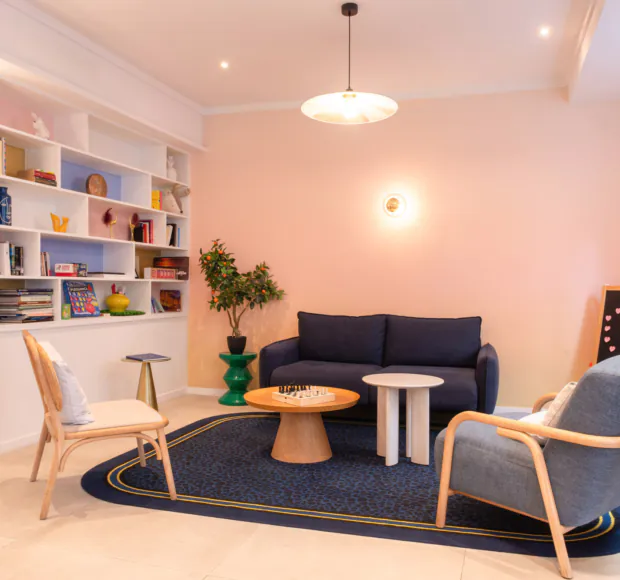 Hall d'accueil de l'hôtel 3 étoiles Acadia à Paris avec des couleurs élégantes et un espace pour enfants.
