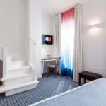 Chambre Duplex avec un escalier et une télévision à l’Hôtel 34B