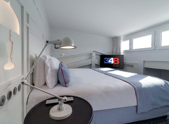 Chambre Duplex avec un lit et une télévision à l’Hôtel 34B