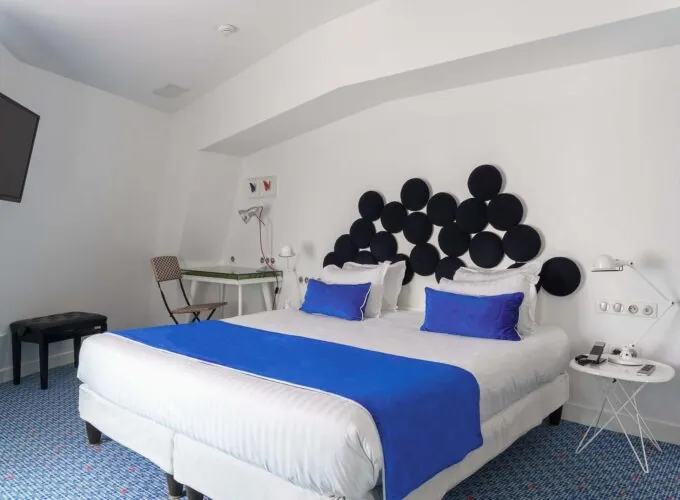 Chambre familiale avec une couverture bleue sur le lit à l’Hôtel 34B