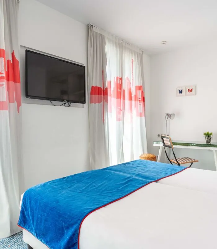 Chambre Familiale Supérieure avec une couverture bleue sur le lit à l’Hôtel 34B