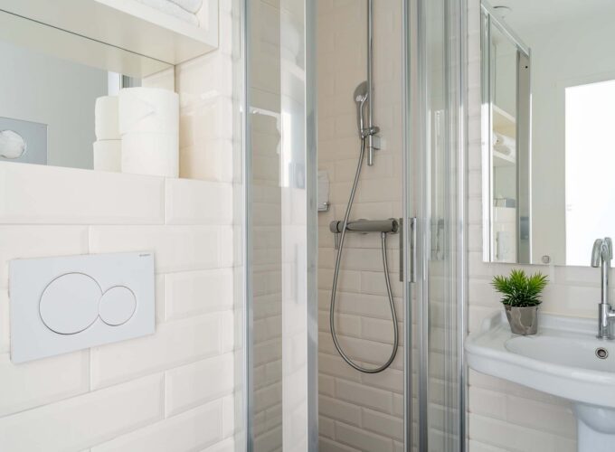 Salle de bain de la Chambre Familiale Supérieure avec une porte de douche coulissante en verre à l’Hôtel 34B