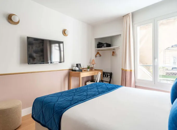 Chambre Double avec un lit, un bureau et une télévision à écran plat à l’hôtel Acadia