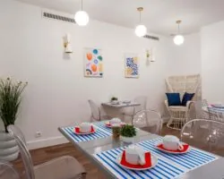 Salle de petit-déjeuner de l'hôtel Acadia à Paris avec buffet varié et ambiance chaleureuse et accueillante.