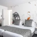 Chambre double de l’hôtel Astoria à Paris, décorée avec des motifs et un flamant rose sur le mur