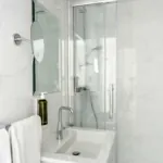 Salle de bain de l’Appartement avec un lavabo, un miroir et une douche à l’hôtel Astoria