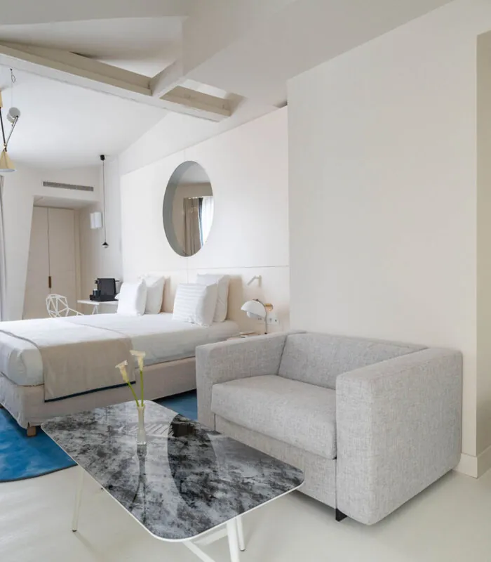 Chambre Exécutive Claudie Haigneré avec un lit, un fauteuil et une table à l’hôtel Astra Opéra