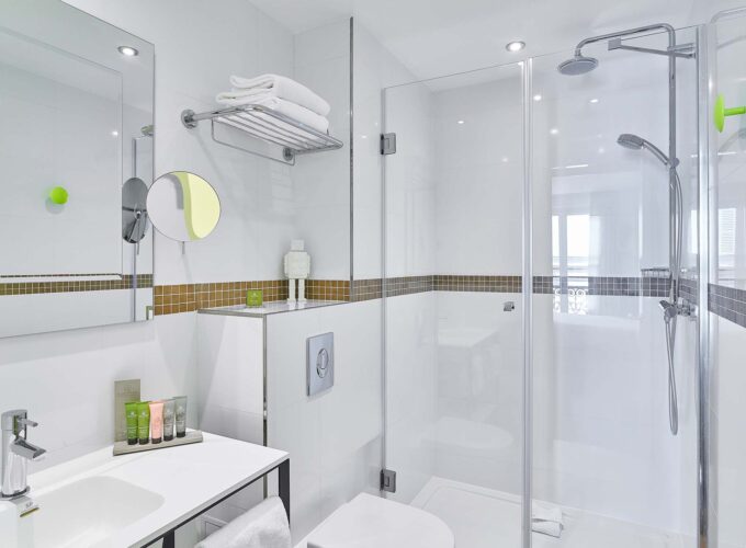 Chambre Twin, salle de bains avec un WC, un lavabo et un miroir à l’hôtel Augustin