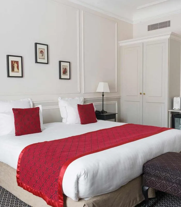 Chambre Double Privilège avec un lit et un miroir à l’Hôtel Bradford Elysées