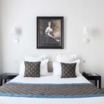 Chambre Double Supérieure – un tableau représentant une femme est accroché au-dessus d’un lit à l’Hôtel Bradford Elysées