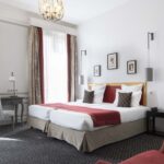 Chambre Twin Supérieure avec deux lits et une chaise à l’Hôtel Bradford Élysées