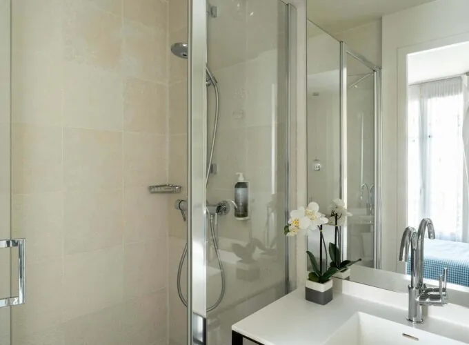 Salle de bain de la Chambre Communicante à l’hôtel Joke avec un lavabo,une douche et un miroir