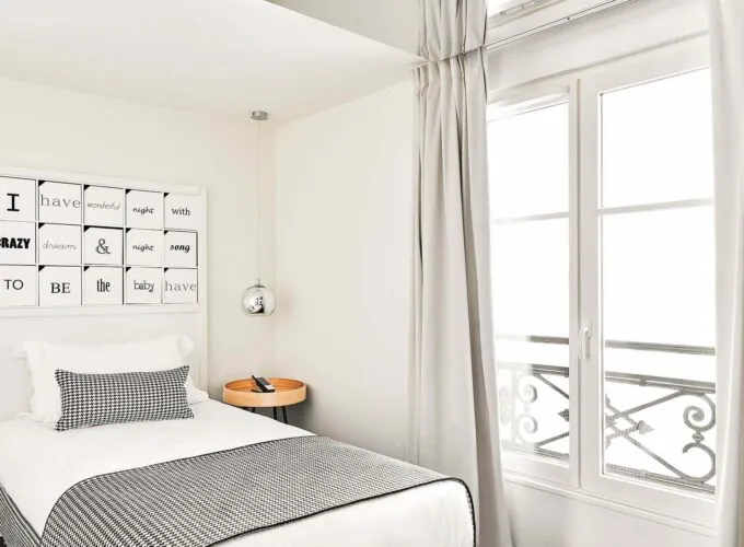 Chambre Single à l’hôtel Joke avec un lit et une enseigne