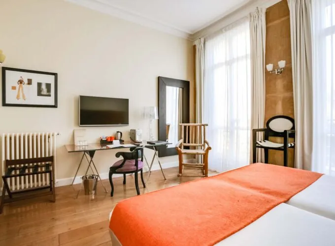 Chambre pour personnes à mobilité réduite à l’hôtel Le 123 Elysées avec un lit, un bureau et une télévision