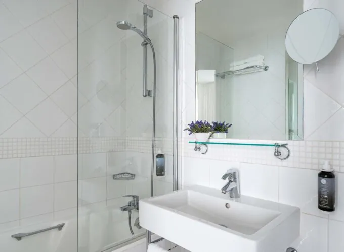 Salle de bain d’une Chambre Double Supérieure avec un lavabo, un miroir et une douche à l’Hôtel Lorette