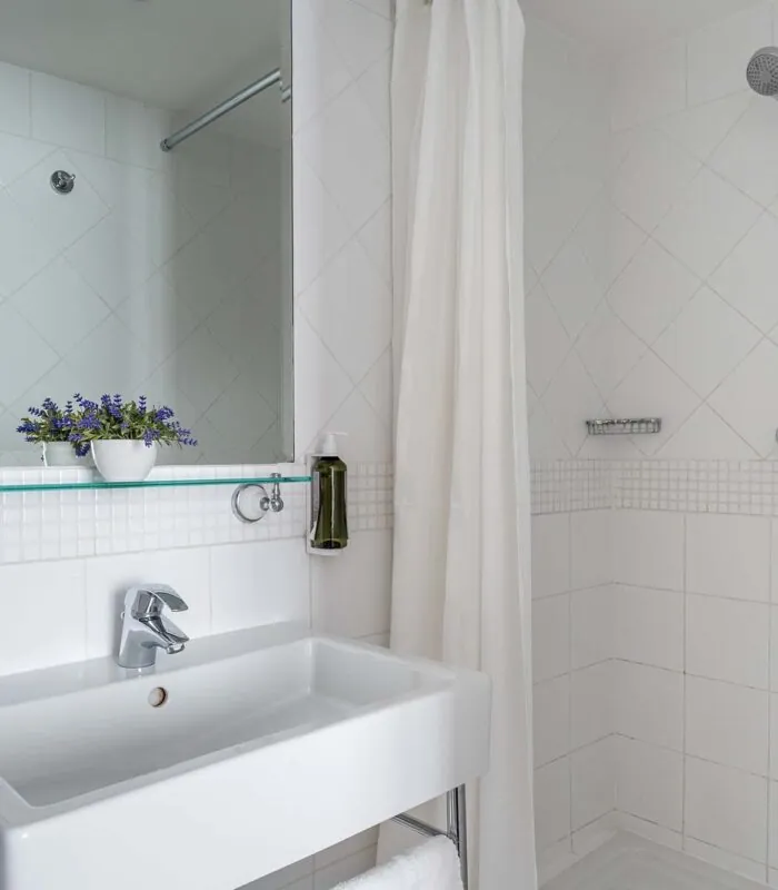 Salle de bain d’une Chambre Single avec un lavabo, un miroir et une douche à l’Hôtel Lorette
