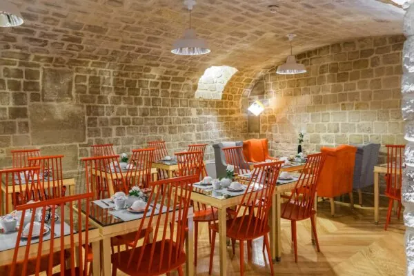 Vue de la salle de petit-déjeuner de l’Hôtel Lorette, un espace accueillant où les clients peuvent profiter d’un buffet varié. L’atmosphère y est chaleureuse et animée