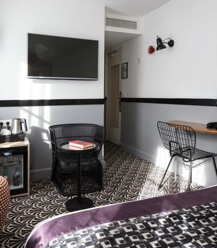 Chambre Double Supérieure avec une chaise et une télévision au mur à l’Hôtel Malte