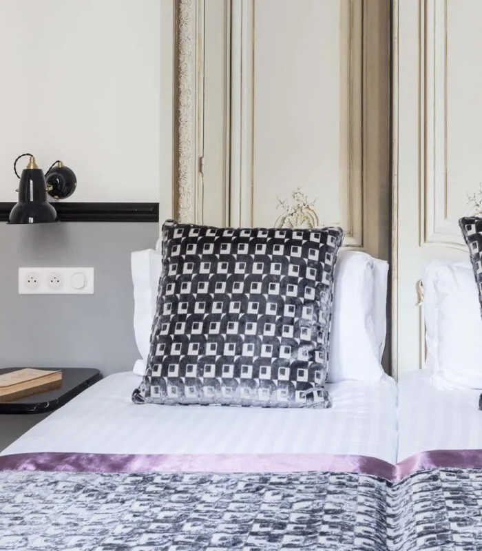 Lit d’une chambre Twin avec un oreiller à motifs noir et blanc à l’Hôtel Malte