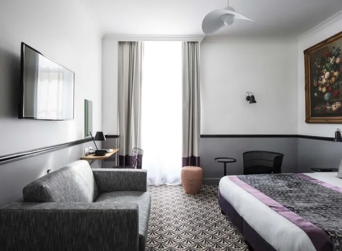 Chambre Privilège avec un canapé et une télévision à écran plat à l’Hôtel Malte