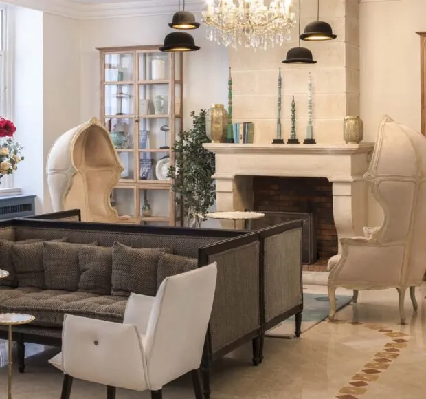 Elegant lounge at the Malte Astotel Hotel in Paris with modern furniture and a fireplace.