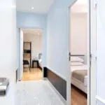 Couloir privatisé menant aux chambres de la chambre communicante avec vue sur un lit simple à l’Hôtel Palm