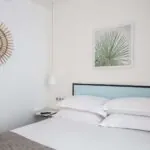 Une chambre d’une chambre familiale avec un lit et un tableau accroché au mur au-dessus à l’Hôtel Palm