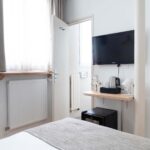 Chambre de la chambre Single Cocoon avec une télévision à écran plat fixée au mur à l’Hôtel Palm