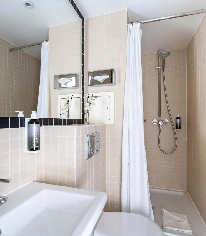 Salle de bain d’une chambre Single avec des toilettes, un lavabo et un rideau de douche à l’Hôtel Palm