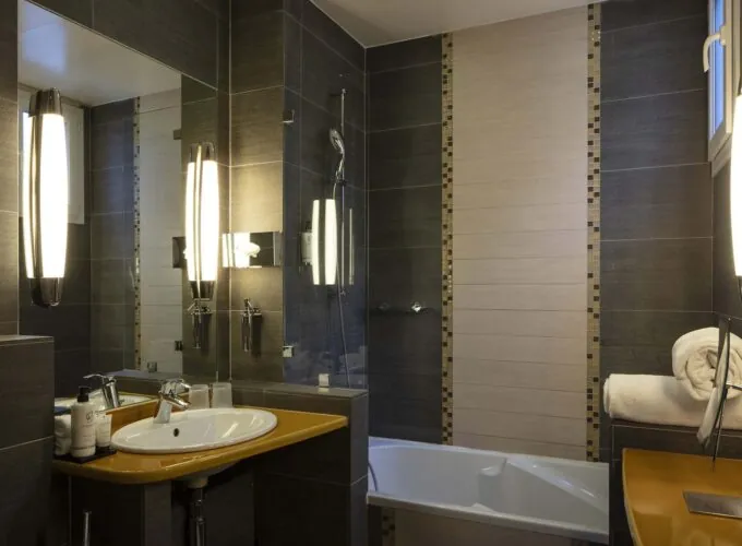 Salle de bain de la chambre familiale supérieure vue Jardin avec un lavabo et une baignoire à l’Hôtel Regent’s Garden