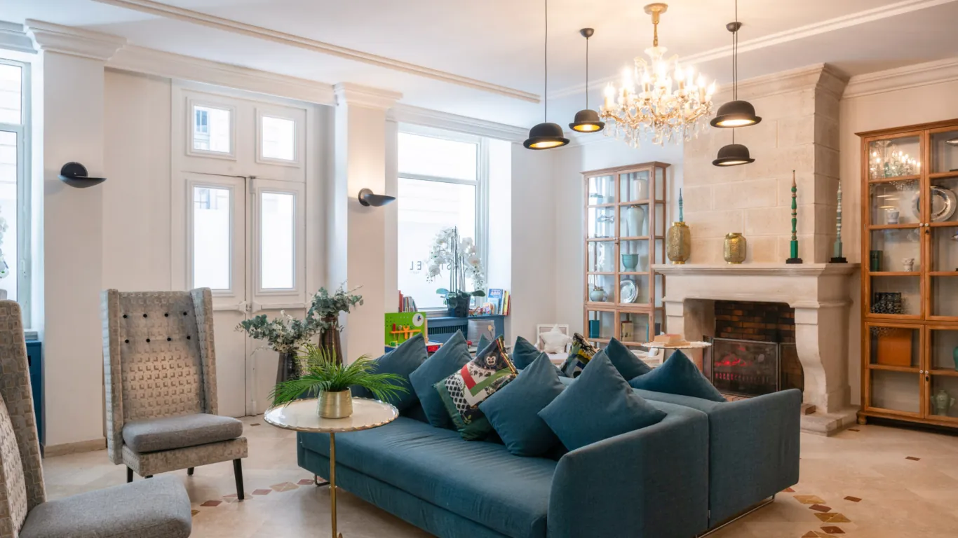 Reception area at the Malte Hotel in Paris with elegant décor, soft lighting and a warm, welcoming atmosphere