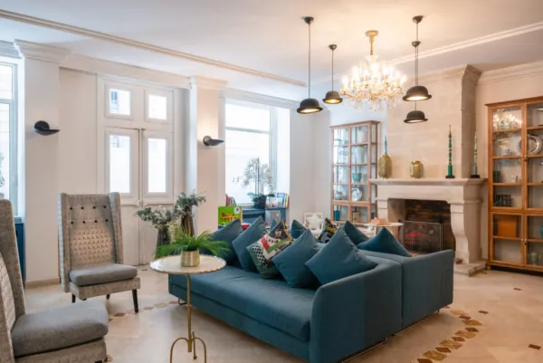 Reception area at the Malte Hotel in Paris with elegant décor, soft lighting and a warm, welcoming atmosphere