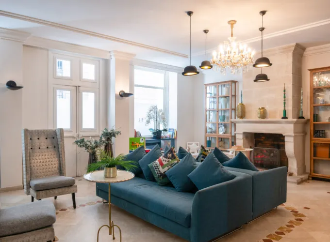 Reception area at the Malte Hotel in Paris with elegant décor, soft lighting and a warm, welcoming atmosphere