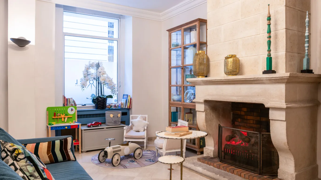 Reception area at the Malte Hotel in Paris with elegant décor, soft lighting and a warm, welcoming atmosphere