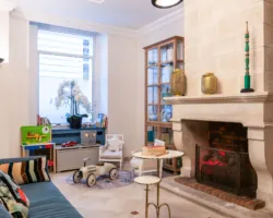 Reception area at the Malte Hotel in Paris with elegant décor, soft lighting and a warm, welcoming atmosphere