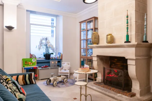 Reception area at the Malte Hotel in Paris with elegant décor, soft lighting and a warm, welcoming atmosphere