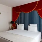 chambre double avec tête de lit rouge et bleue à l’hôtel astra opéra