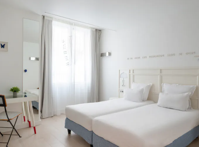 chambre twin accessible avec deux lits simples et décoration bleu clair à l’hôtel 34b