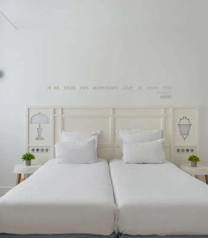 chambre twin accessible avec deux lits simples et décoration bleu clair à l’hôtel 34b