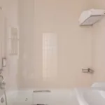 Salle de bain de la Chambre Familiale Privilège à l’hôtel Le 123 Elysées avec un lavabo et une baignoire