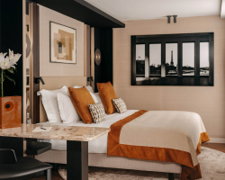 Découvrez la Chambre Prestige avec balcon de l’Hôtel Barnett, un espace spacieux et élégant aux tons chaleureux, avec literie confortable, coin bureau, détails terracotta et décoration contemporaine inspirée de Paris.